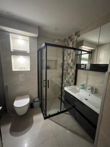 a bathroom with a shower and a toilet and a sink at Bella Mela in Tuzla