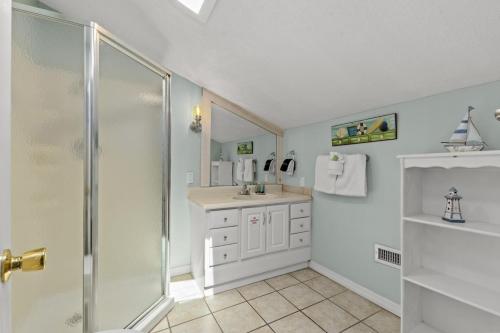 a bathroom with a shower and a sink at SeaCove Steps 2 Priv Beach Backyard Comm Pool in Destin