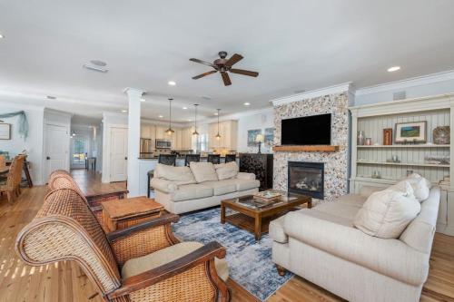 a living room with two couches and a fireplace at Yellow Pearl Pool heat GolfCart deals Steps2Beach in Destin