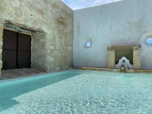 a large swimming pool in a building with water in it at Casa do Jogo in Dous Portos