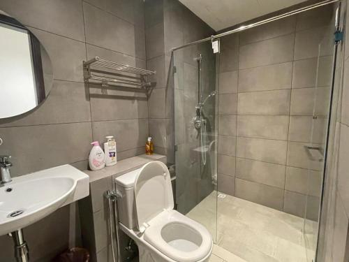 a bathroom with a shower and a toilet and a sink at K Avenue Kota Kinabalu in Donggongon