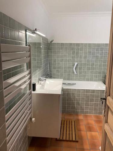 une salle de bain avec un lavabo et une baignoire dans l'établissement Chalet accueillant avec cheminée à 5 min du centre, à Saint-Gervais-les-Bains
