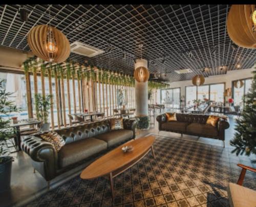 a lobby with couches and a table in a room at Cosy Home - Caesar Resort & SPA in İskele
