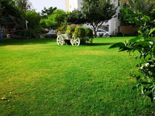 a park with a bench in the grass at Cosy Home - Caesar Resort & SPA in İskele