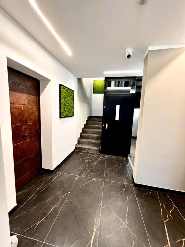 a hallway with a black door and a staircase at CINQUE TERRE Hub Suite ART in La Spezia