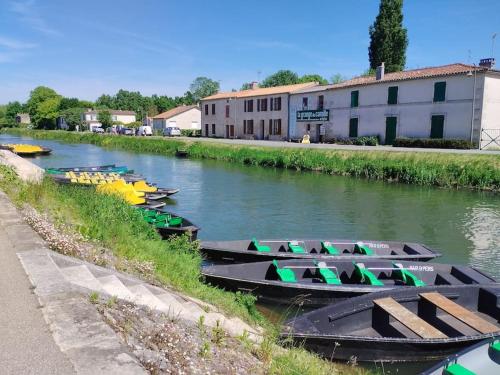 a group of boats parked on the side of a river at Gîte le Vieux Moulin in Sansais