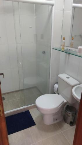 a bathroom with a shower and a toilet and a sink at Ecoapê in Petrópolis