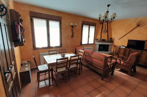 a living room with a couch and a table and a fireplace at Casas Rurales Mi Reja B in Santa María de Riaza