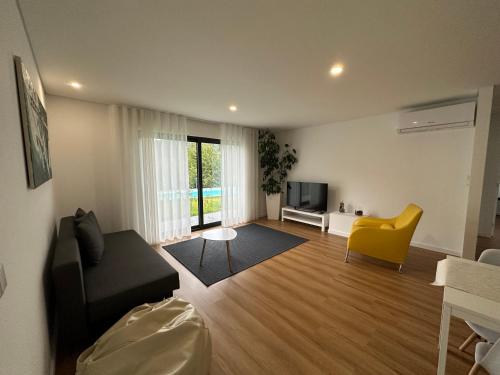 a living room with a couch and a tv at Ri&Vale Alojamentos in Vieira do Minho