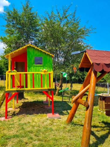 a playground with a play house and a slide at Cabana A-frame Moon Predelut in Predeluţ