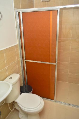 a bathroom with a toilet and a shower at Hotel Flamante Bulevar in Bogotá