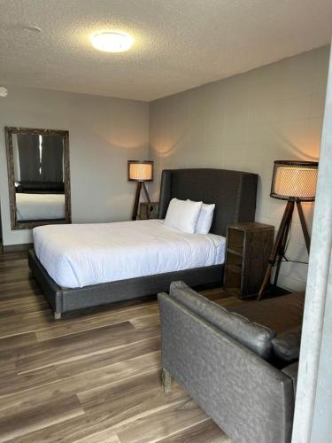 a hotel room with a bed and a couch at Parkside Inn in Grande Prairie