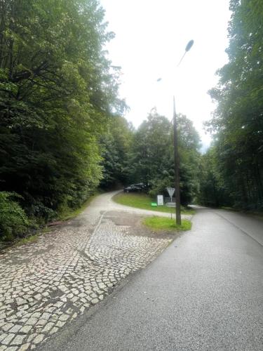an empty road with a pole on the side of it at Apartamenty Ustroń Wczasowa 90 in Ustroń
