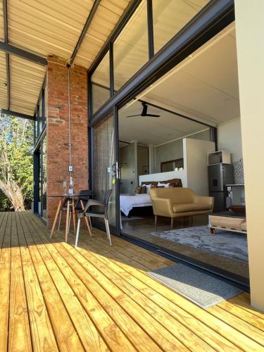 an open living room with a bed and a bedroom at Modern Apartment on Letaba River in Tzaneen