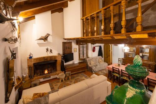 a living room with a couch and a fireplace at Chalet Corona in Giustino