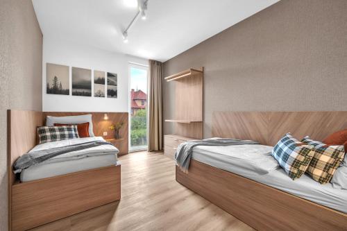 Postel nebo postele na pokoji v ubytování Apartment Viva Vrchlabí A21