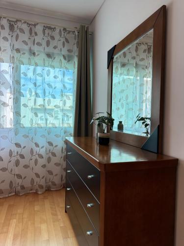 a dressing room with a dresser and a mirror at DunasDaVagueira in Gafanha da Boa Hora