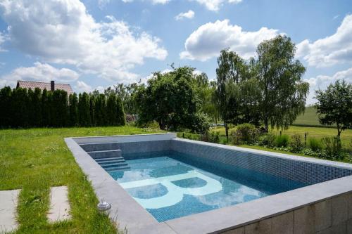 a swimming pool in the middle of a yard at Luxury Loft with Pool close to Munich 130qm in Petershausen