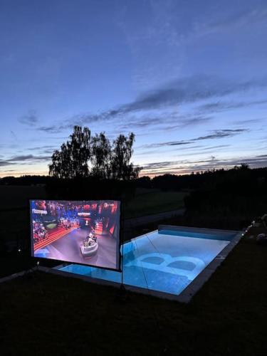 a large screen tv with a video game on it at Luxury Loft with Pool close to Munich 130qm in Petershausen