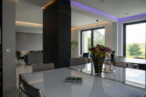 a living room with a vase of flowers on a counter at Luxury Loft with Pool close to Munich 130qm in Petershausen