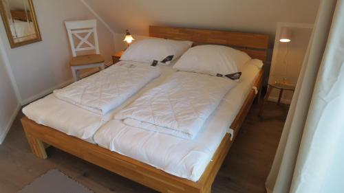 a bedroom with two beds with white sheets at Seeblick in Groß Schwansee