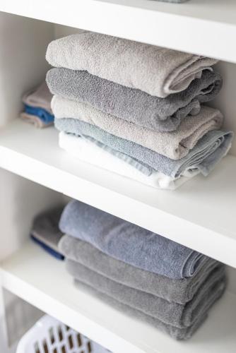 a stack of towels on a closet shelf at Luxury Downtown Townhome Unit 13 in Cleveland