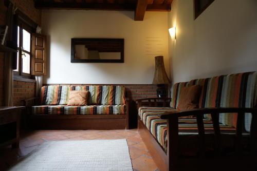 a living room with a couch and a mirror at HOTEL RURAL ARREDONDO in Celorio
