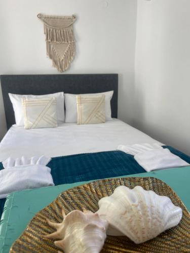 a bedroom with a bed with a shell on it at Silvia in Skala Sotiros