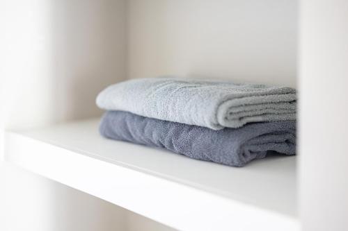 a stack of towels sitting on a shelf in a bathroom at Luxury Downtown Townhome Unit 14 in Cleveland