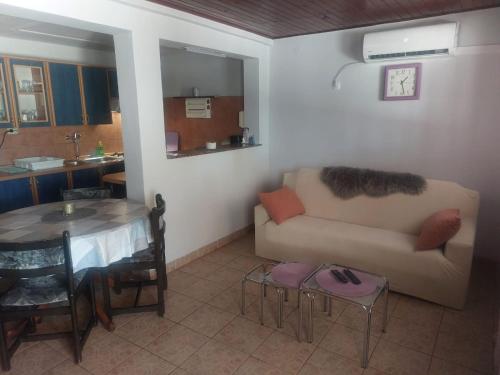 a living room with a couch and a table at Sandra Apartmani 1 in Zaostrog