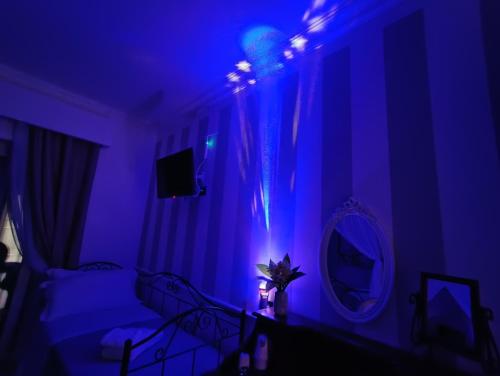 a room with a bed with a blue light at Relais Tiaré Bed and Breakfast in Bacoli