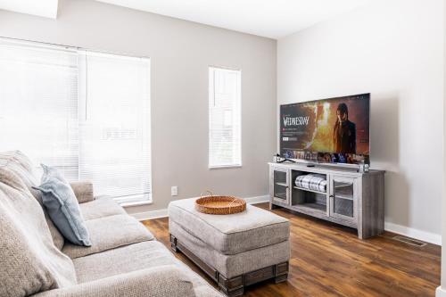 a living room with a couch and a flat screen tv at Luxury Downtown Townhome Unit 13 in Cleveland