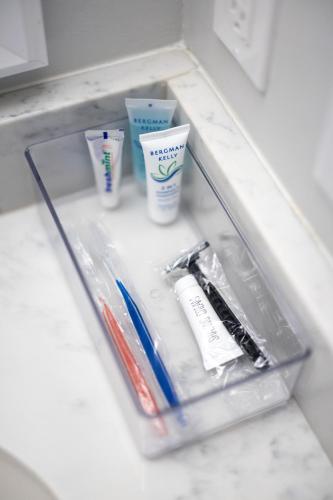 a drawer with toothbrushes and toothpaste on a counter at Luxury Downtown Townhome Unit 7 in Cleveland
