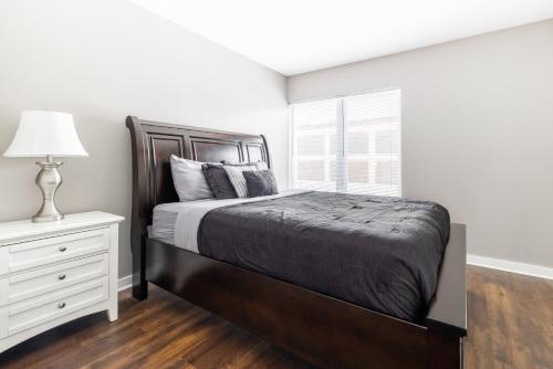 a bedroom with a large bed and a window at Luxury Downtown Townhome Unit 7 in Cleveland
