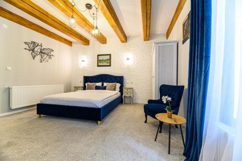 a bedroom with a bed and a table and a chair at Dallure House Boutique Brasov in Braşov