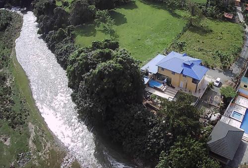 an aerial view of a house next to a river at Villa La Grande in Jarabacoa