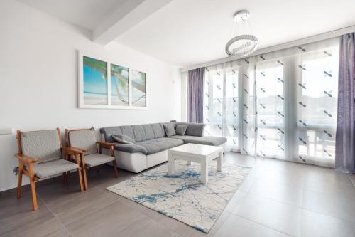 a living room with a couch and two chairs at Apartments FourRoses in Ulcinj