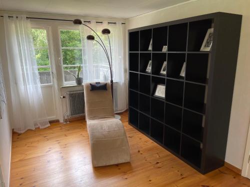 a living room with a large black book shelf at Skirsnäs gård in Växjö