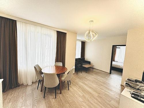 a dining room with a table and chairs in a room at Crystal Loft Block A Apartment 103 in Bakuriani