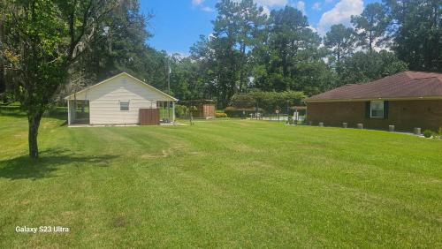 a large yard with a house and a building at private getaway in Perkins