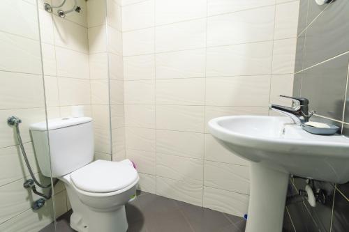 a bathroom with a toilet and a sink at Apartments FourRoses in Ulcinj