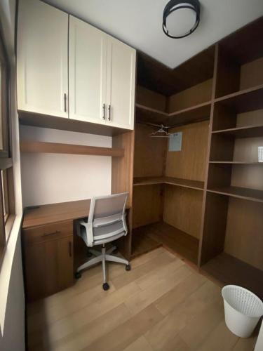 a office with a chair and a desk and shelves at Apartamento #12 Portal de Occidente in Quetzaltenango