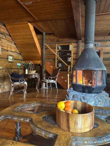 a room with a stove with a bowl of fruit at Rustic Beaverfoot Lodge Room N5 in Parson
