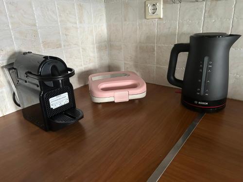 a coffee maker and a blender on a table at Among the pines in Katakolon