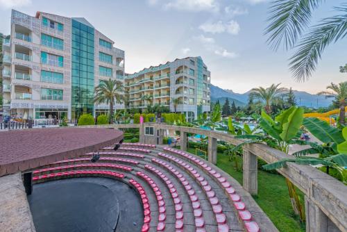 a baseball dugout at a resort with buildings at Grand Ring Hotel in Beldibi