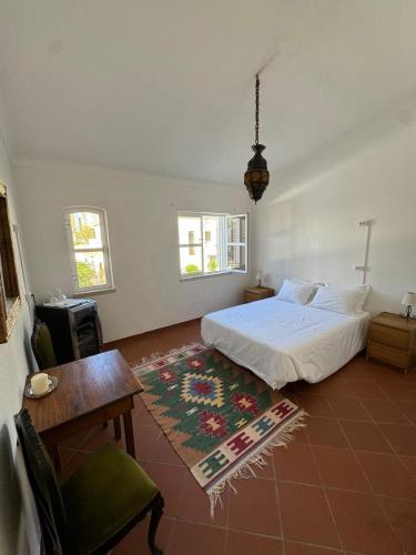 a bedroom with a bed and a table and a table sidx sidx at Villa 46 Hostel in Lagos