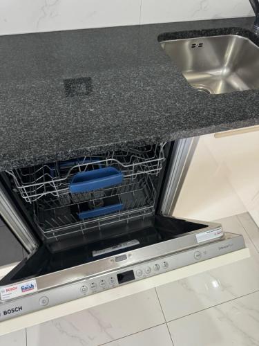 a dishwasher in a kitchen with a sink at Apartments Funtana with pool in Funtana