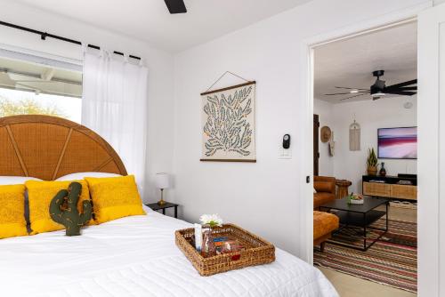a bedroom with a large bed with yellow pillows at Designer Home with Guest House, Pool, Hot Tub in Tucson