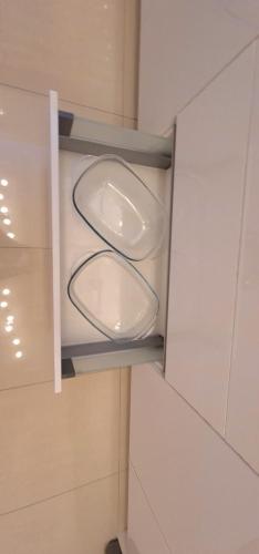 a bathroom with two urinals in a room at London Luxury 3 bedroom flat, 2 bathrooms, Living Room, free parking, 4 mins to station, garden in Ilford