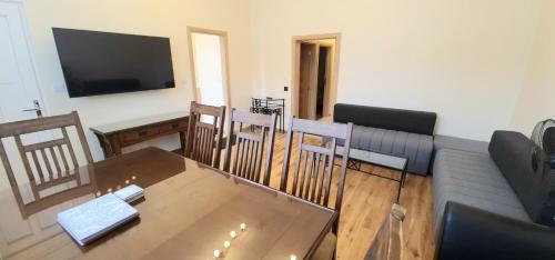 a living room with a couch and a table and chairs at London Luxury 3 bedroom flat, 2 bathrooms, Living Room, free parking, 4 mins to station, garden in Ilford